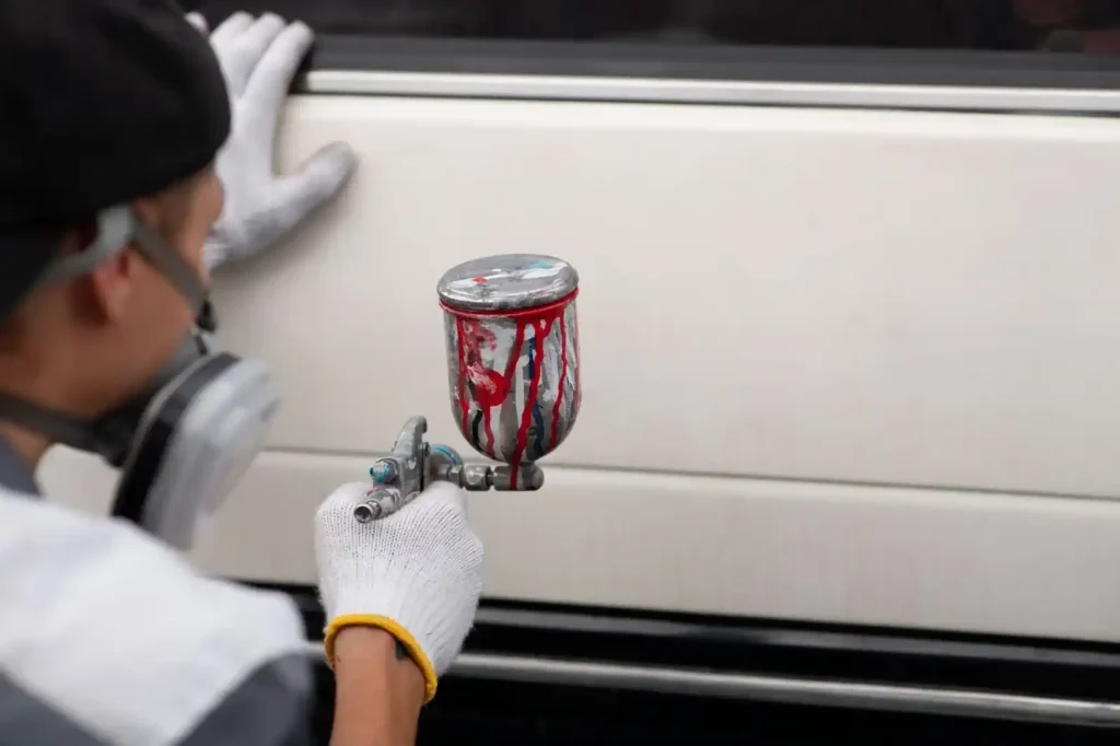 Pistola con restos de pintura preparada con thinner para pintura automotriz